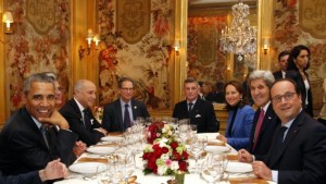 President Barack Obama, left, sits with French President Francois Hollande, right, as they have dinner at the Ambroisie restaurant in Paris, France, with Secretary of State John Kerry, 2nd right, French Minister for Ecology, Sustainable Development and Energy Segolene Royal, 3rd right, and French Foreign Minister, Laurent Fabius, 3rd left, Monday, Nov. 30, 2015. Obama is in France for a two-day visit as part of the COP21, the United Nations Climate Change conference. Other officials are : Translator, Thomas Ronkin, 2nd left, Charles Kupchan, top left, and French President Hollande's Military Chief of Staff General Benoit Puga, top right. (AP Photo/Thibault Camus, Pool)